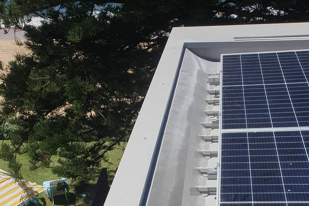 Karben gutter guard on a Kliplok metal roof beside solar panels