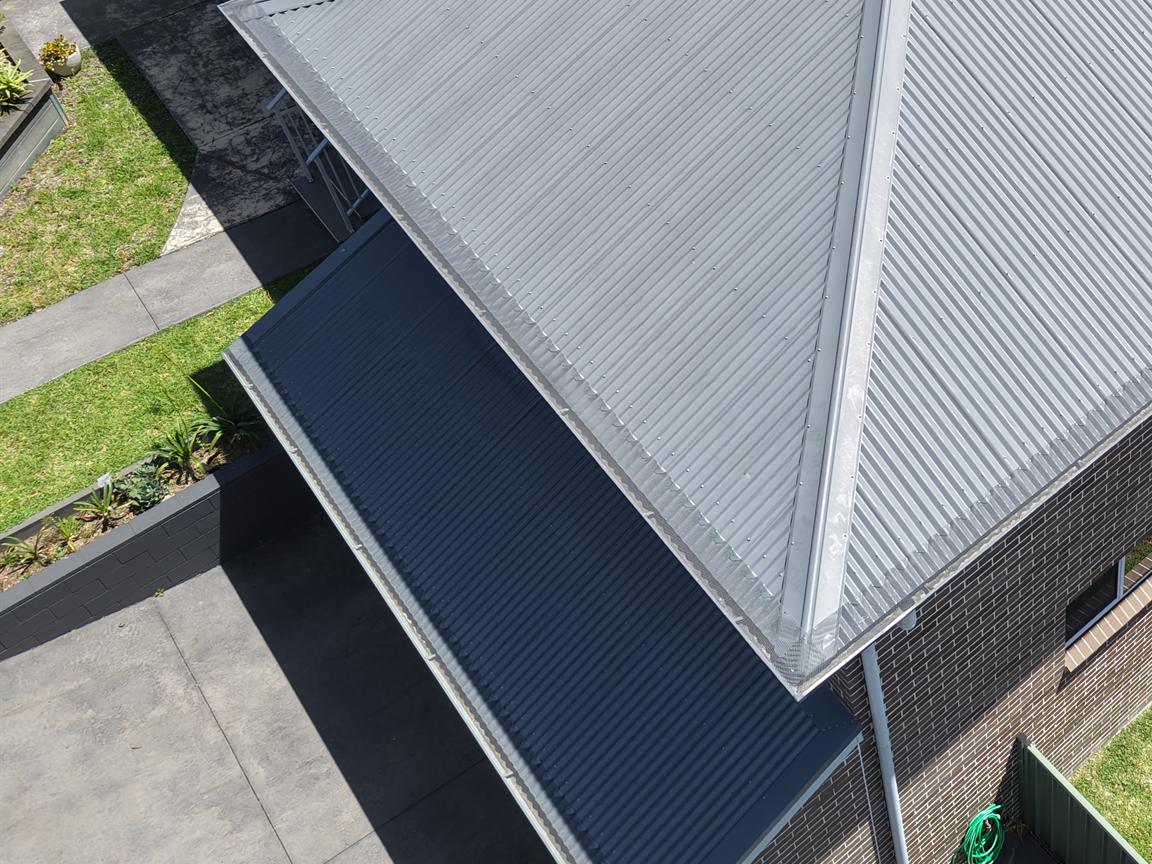 Drone close-up of mesh gutter guard along the eaves of a home