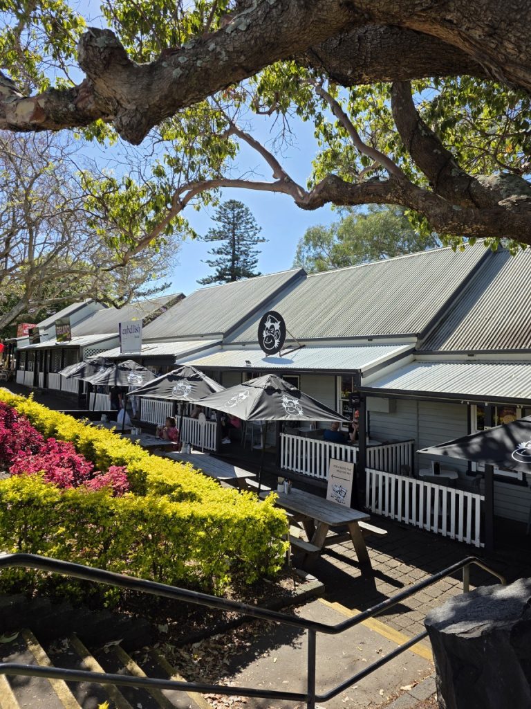 Historic timber verandahs and gardens along Collins Street in Kiama