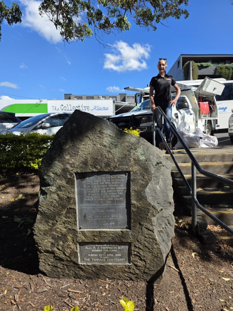 Kasey at Kiama Terrace Houses beside the IMG work vehicle