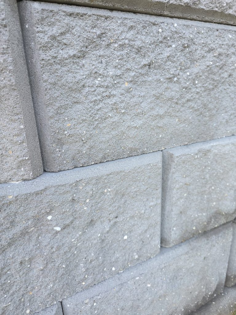 Close-up of the clean retaining-wall blockwork after pressure cleaning in Mount Ousley