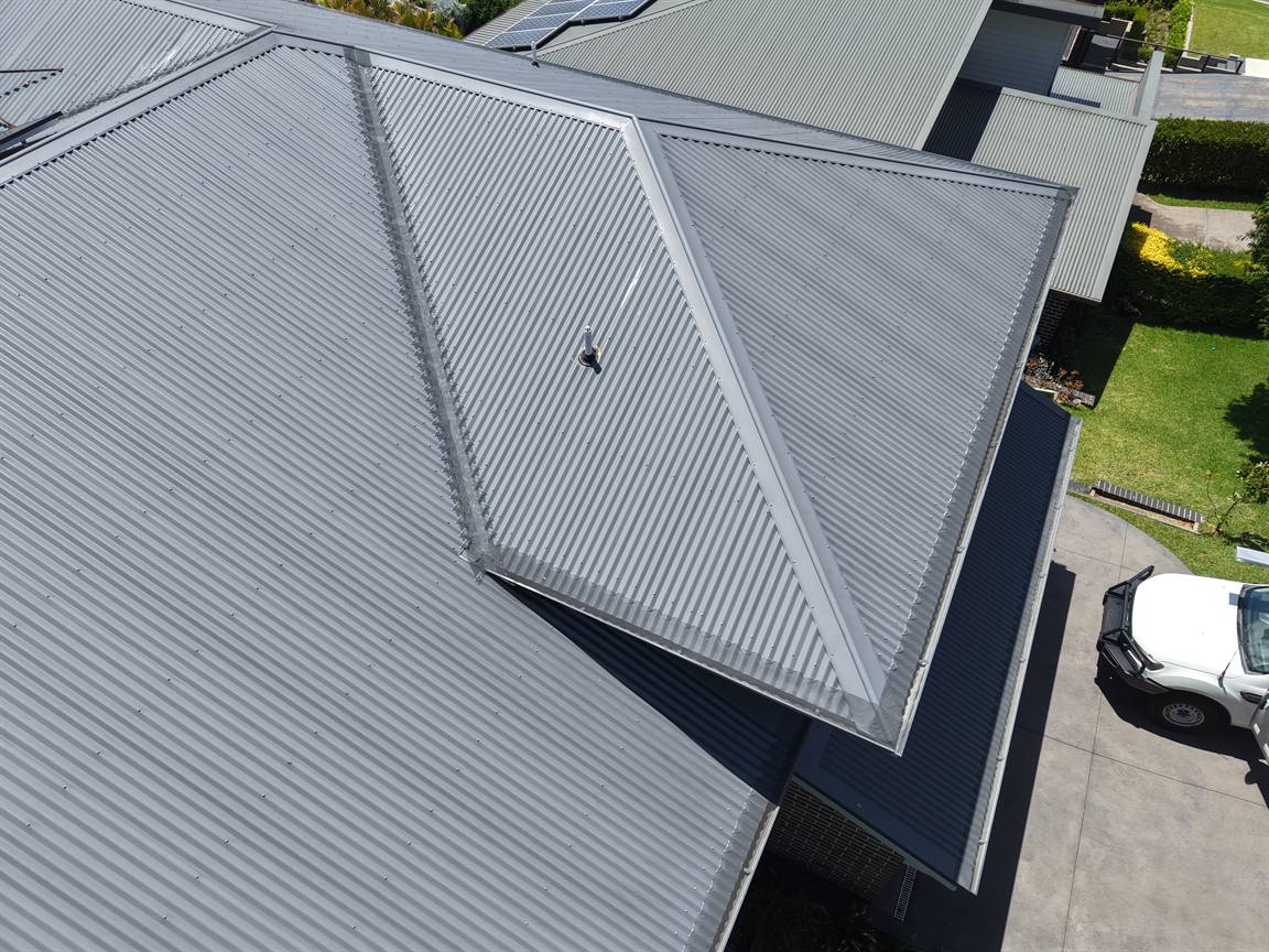 Drone view of a grey Colorbond hip roof with gutter guard fitted