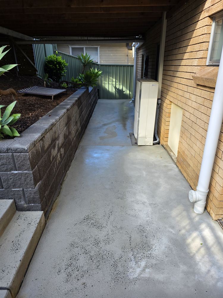Side path and block garden wall after pressure cleaning in Mount Ousley