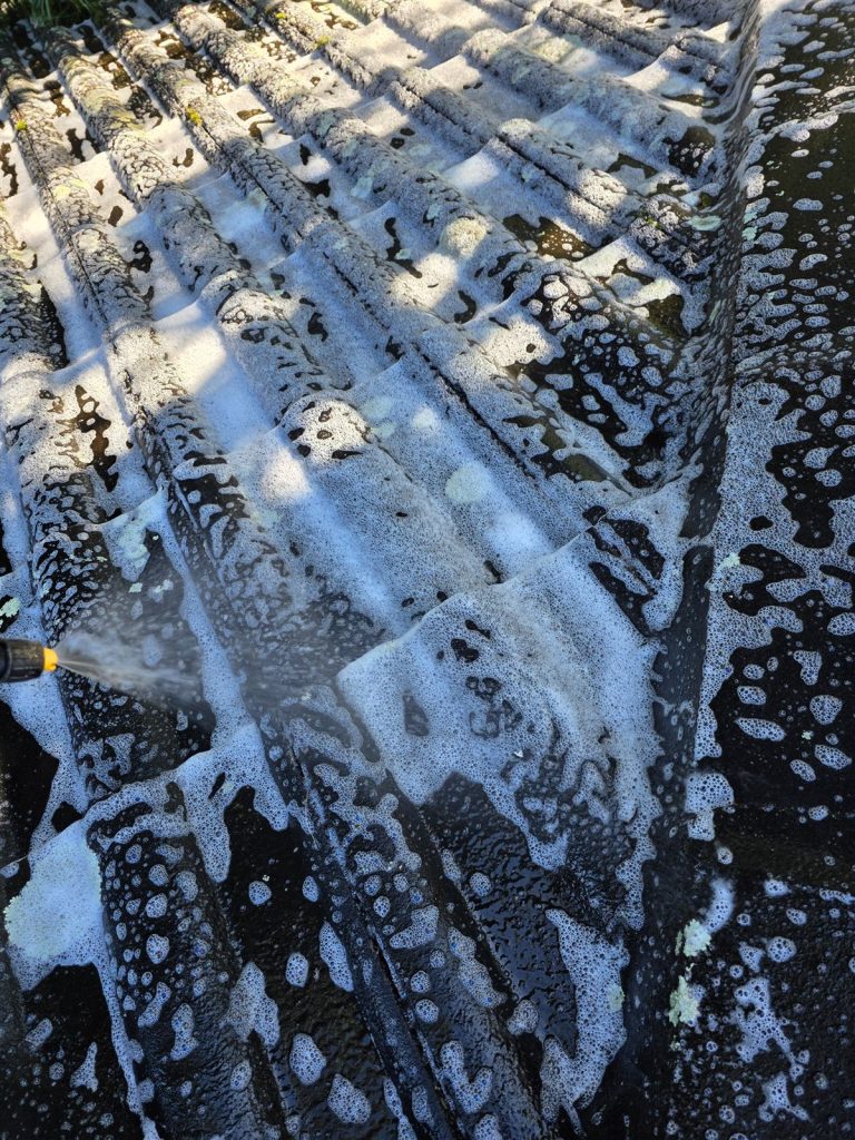 Soft wash treatment going onto a roof in Farmborough Heights