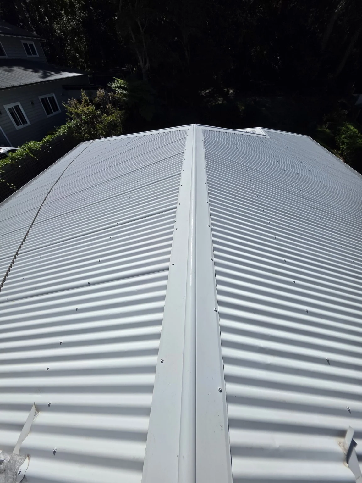 Close view along the clean ridge and corrugated roof sheets after the Wombarra wash