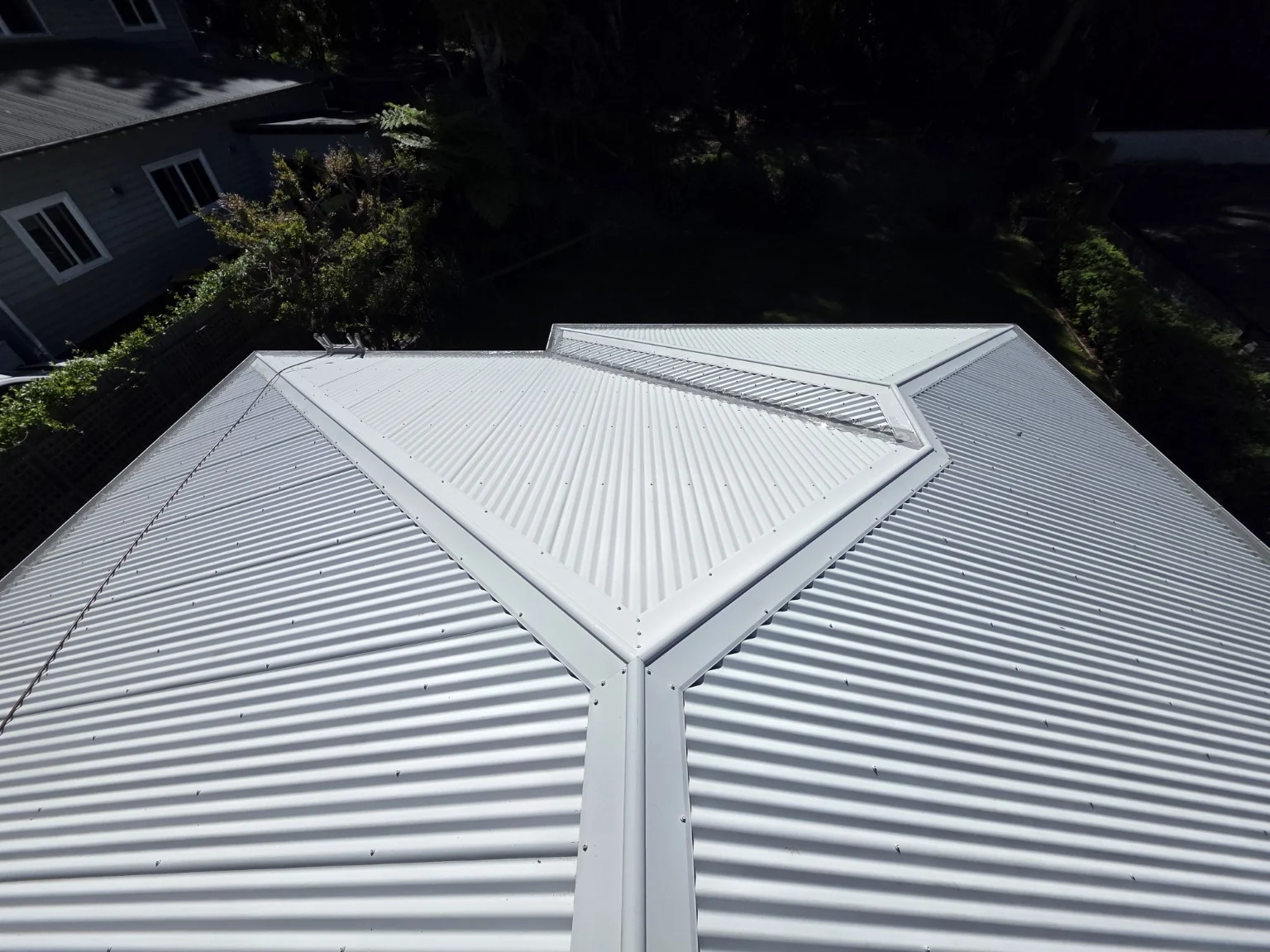 Wombarra roof after washing, showing clean corrugated roof sheets and the intersecting roof lines